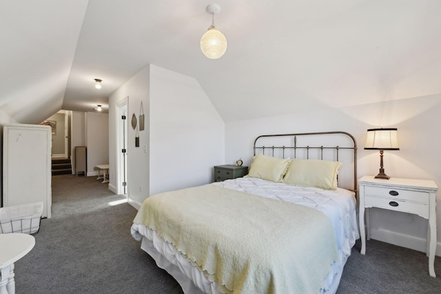 bedroom with lofted ceiling and dark carpet