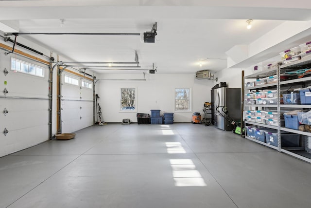 garage featuring a garage door opener and stainless steel fridge