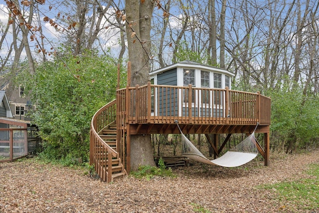 rear view of house featuring a wooden deck