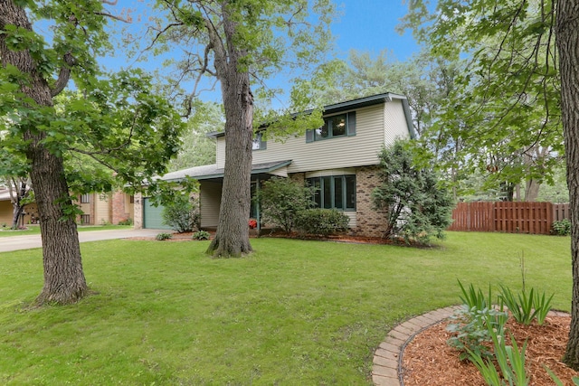 8385 Pleasant View Dr, Mounds View, MN 55112 - view of front of house with a garage, brick siding, and concrete driveway