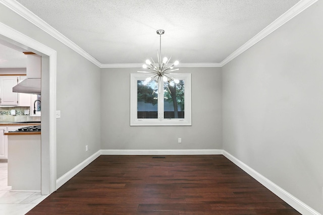 8385 Pleasant View Dr, Mounds View, MN 55112 - unfurnished dining area featuring a chandelier, wood finished floors, ornamental molding, and a textured ceiling