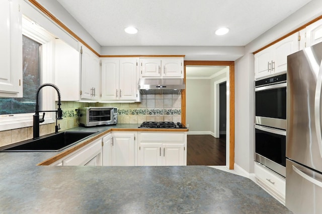 8385 Pleasant View Dr, Mounds View, MN 55112 - kitchen featuring stainless steel appliances, range hood, white cabinetry, and recessed lighting