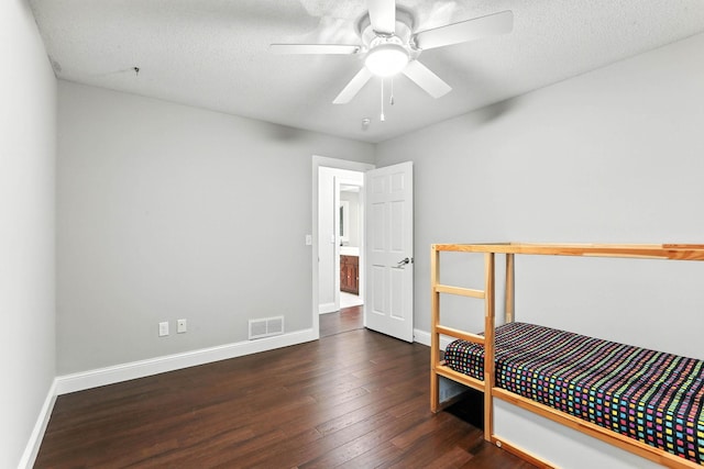 8385 Pleasant View Dr, Mounds View, MN 55112 - unfurnished bedroom with hardwood / wood-style floors and a textured ceiling