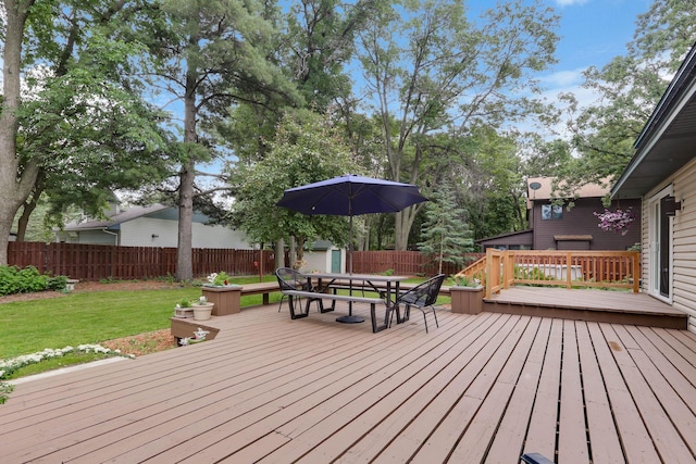 8385 Pleasant View Dr, Mounds View, MN 55112 - wooden terrace with a shed, outdoor dining area, and a fenced backyard