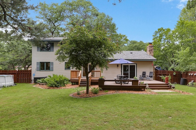 8385 Pleasant View Dr, Mounds View, MN 55112 - back of property featuring a fenced backyard, a wooden deck, and a chimney