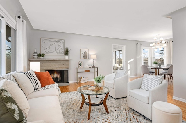 living room with a chandelier and light wood-type flooring