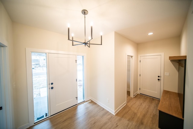 entryway featuring hardwood / wood-style flooring and an inviting chandelier