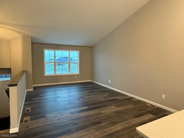 unfurnished living room with dark hardwood / wood-style floors and lofted ceiling