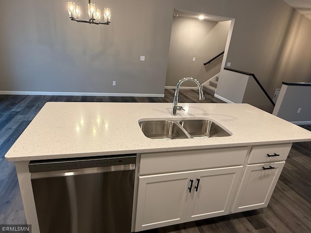 kitchen featuring pendant lighting, sink, white cabinetry, and dishwasher