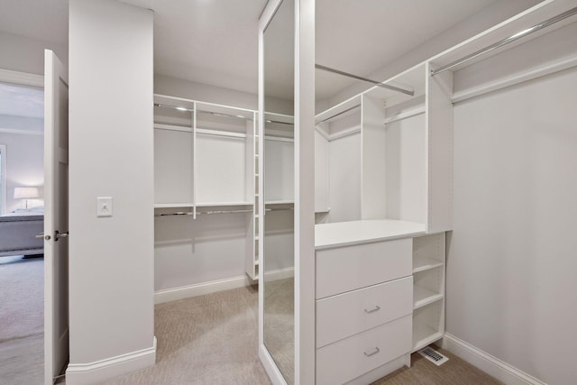 walk in closet featuring carpet floors