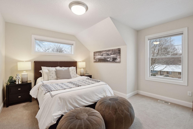 bedroom featuring light carpet and vaulted ceiling