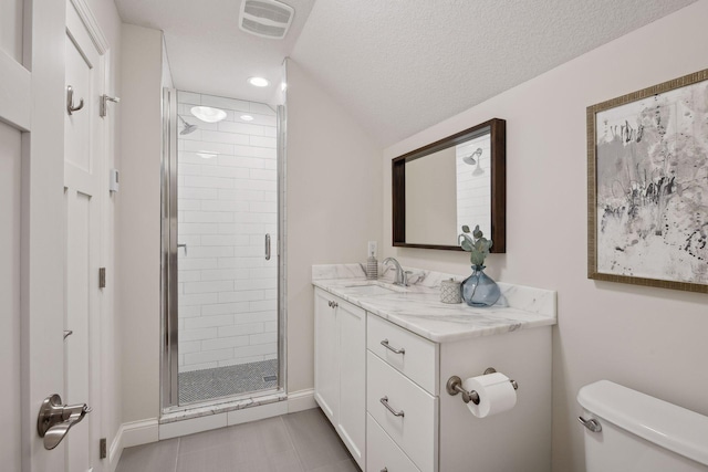 bathroom with tile patterned flooring, a textured ceiling, toilet, vanity, and a shower with shower door