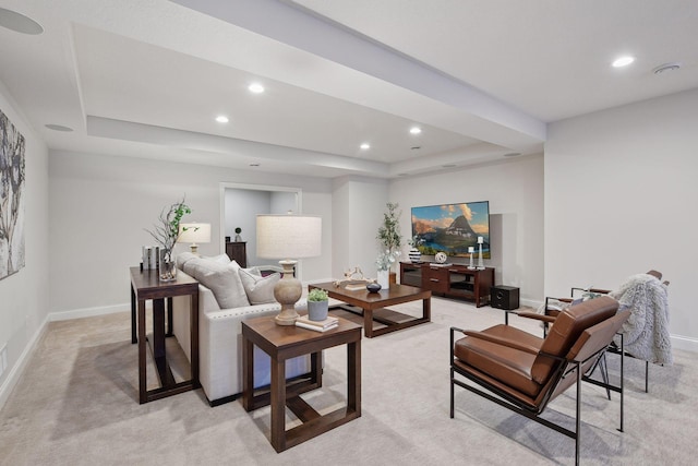 living room with light colored carpet and a tray ceiling