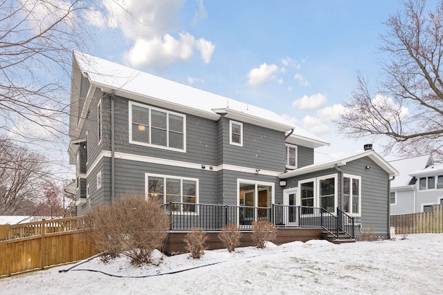 snow covered property featuring a wooden deck