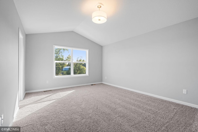 interior space featuring carpet and lofted ceiling