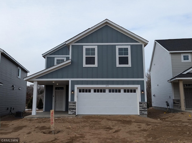 view of front of home featuring a garage and central AC