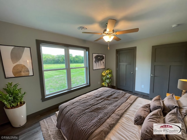 bedroom with ceiling fan and dark hardwood / wood-style floors