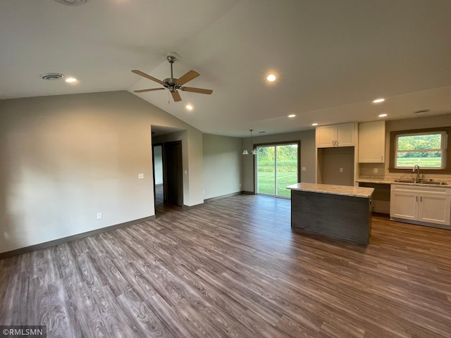 kitchen featuring ceiling fan, sink, white cabinets, hardwood / wood-style floors, and a center island