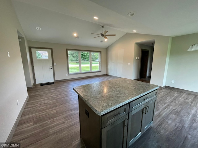 kitchen with a center island, dark hardwood / wood-style floors, ceiling fan, and lofted ceiling