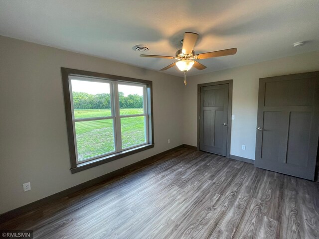 unfurnished bedroom with wood-type flooring and ceiling fan