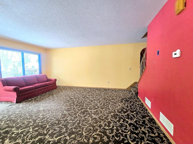 carpeted living room with a textured ceiling