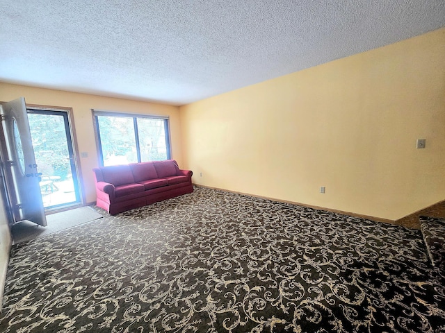 living room featuring carpet flooring and a textured ceiling