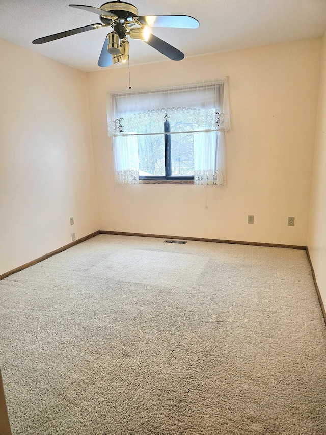 unfurnished room with ceiling fan and carpet floors