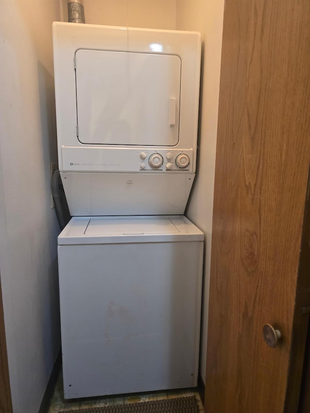 laundry room featuring stacked washer and clothes dryer