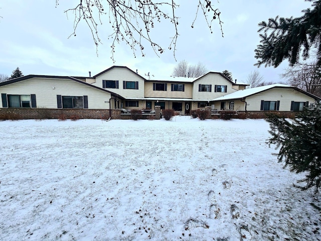 view of snow covered rear of property