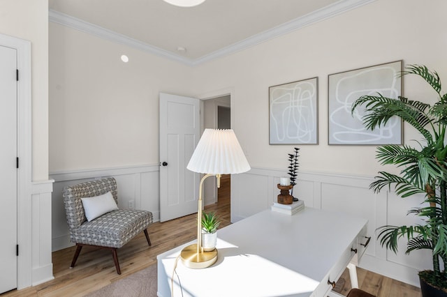 office area with crown molding and light hardwood / wood-style floors