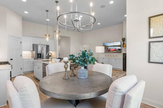 dining space featuring a notable chandelier and light wood-type flooring