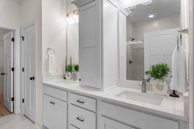 bathroom with a shower with door and vanity