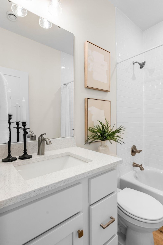 full bathroom with toilet, vanity, and shower / bath combo with shower curtain