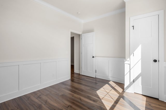 spare room with dark hardwood / wood-style floors and ornamental molding