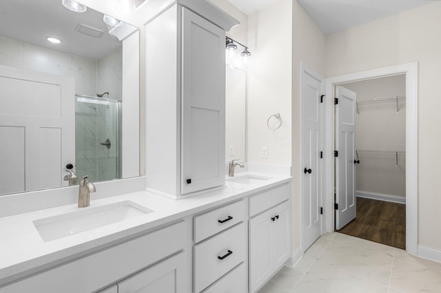 bathroom with vanity, tile patterned flooring, and a shower with door