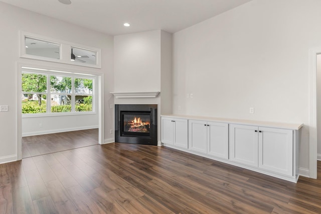 unfurnished living room with dark hardwood / wood-style floors