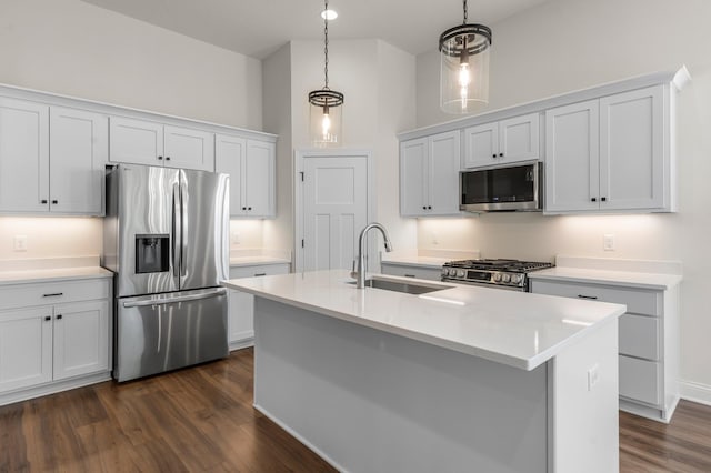 kitchen featuring sink, pendant lighting, white cabinets, and stainless steel appliances