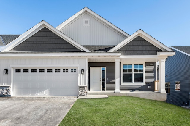 view of front of home featuring a garage, a front lawn, and a porch