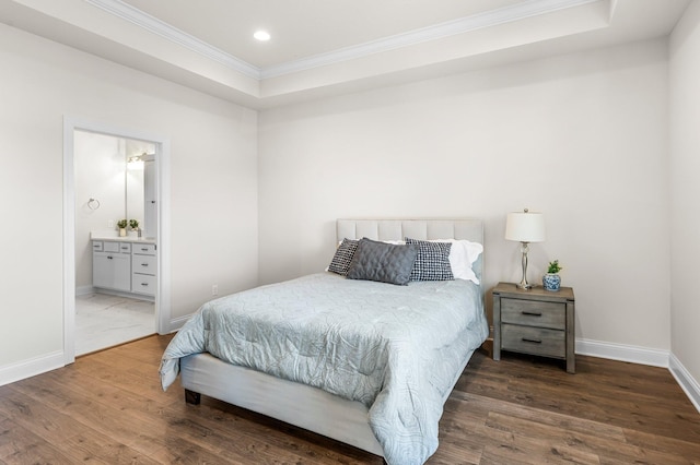 bedroom with ensuite bathroom, dark wood-type flooring, crown molding, and a raised ceiling