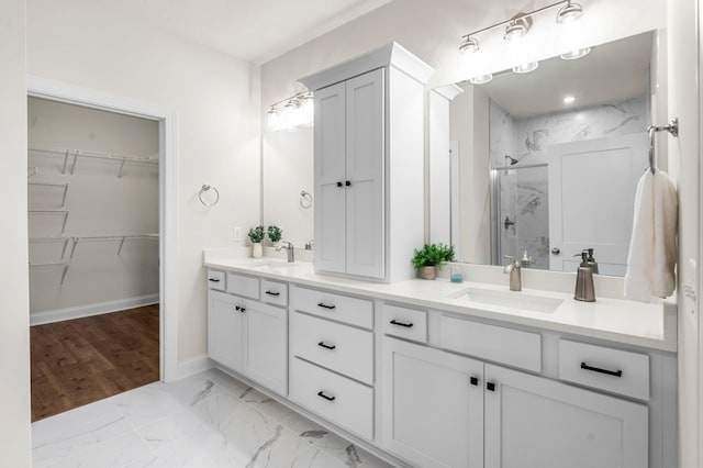 bathroom featuring walk in shower and vanity