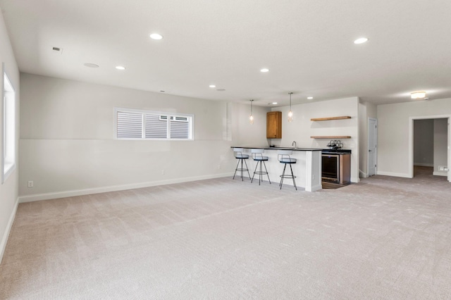 unfurnished living room with light carpet and bar