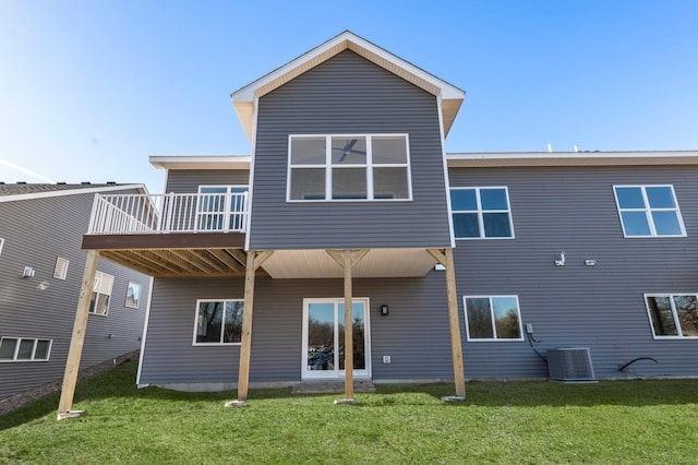 back of house with a deck, central AC unit, and a lawn