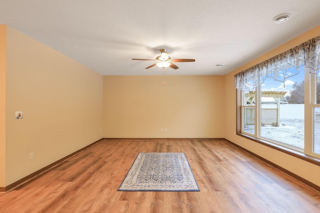 empty room featuring ceiling fan and light wood-type flooring