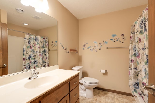 bathroom with vanity, toilet, and curtained shower