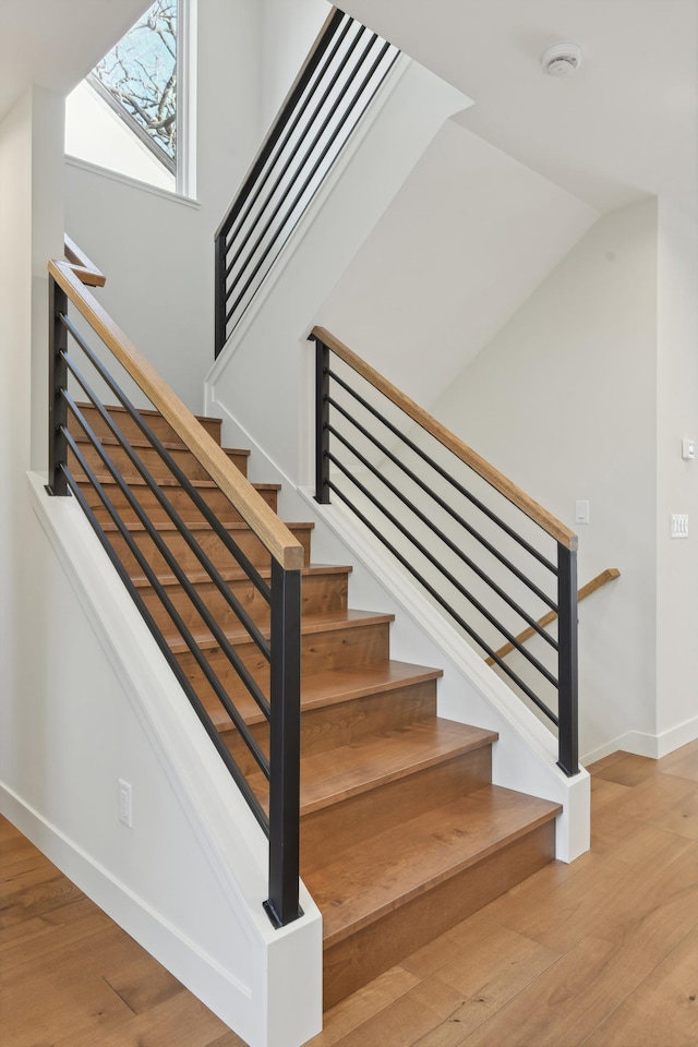 stairway with hardwood / wood-style flooring