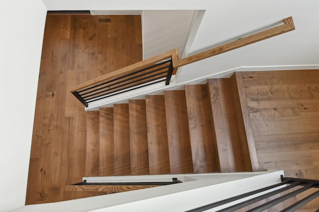 stairway featuring wood walls