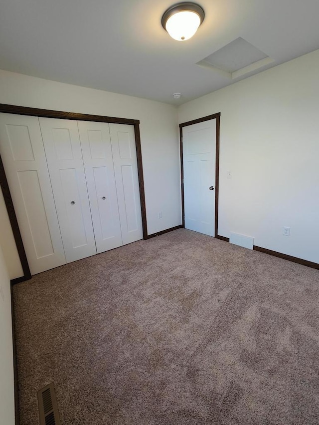 unfurnished bedroom with carpet and a closet