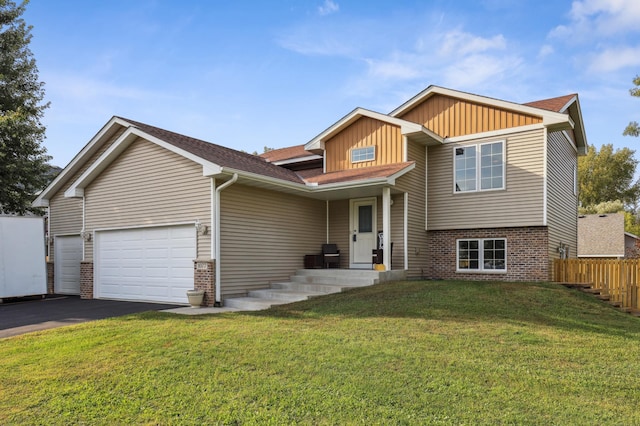 view of front of home with a front yard and a garage