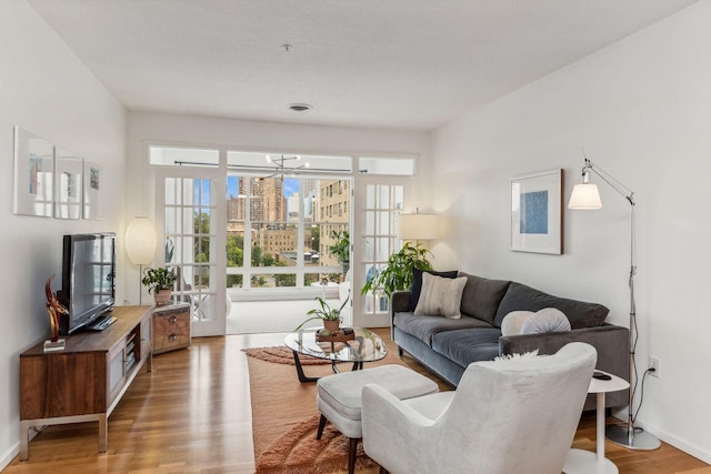 living room with wood-type flooring and a notable chandelier