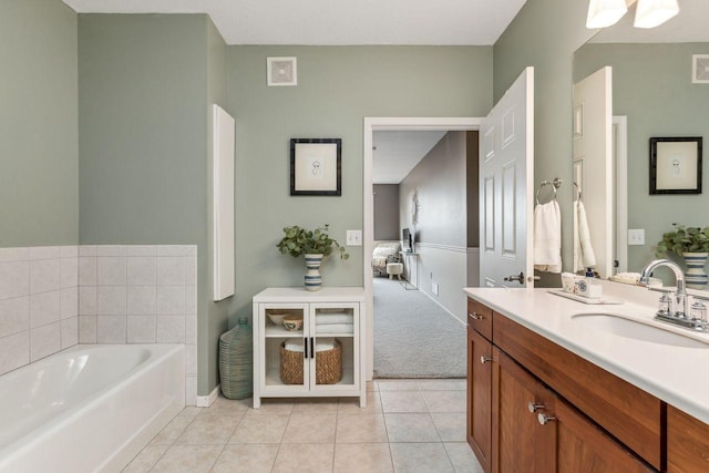 bathroom featuring vanity, tile patterned flooring, and a washtub